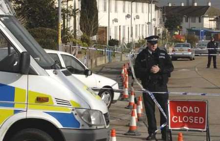 Police officers outside the property where the body was found. Picture: MATT READING