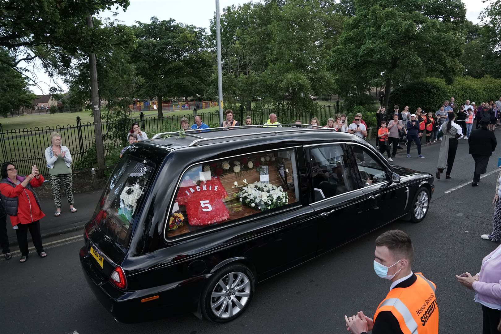 Crowds line the streets as the funeral cortege passes by (Owen Humphreys/PA)