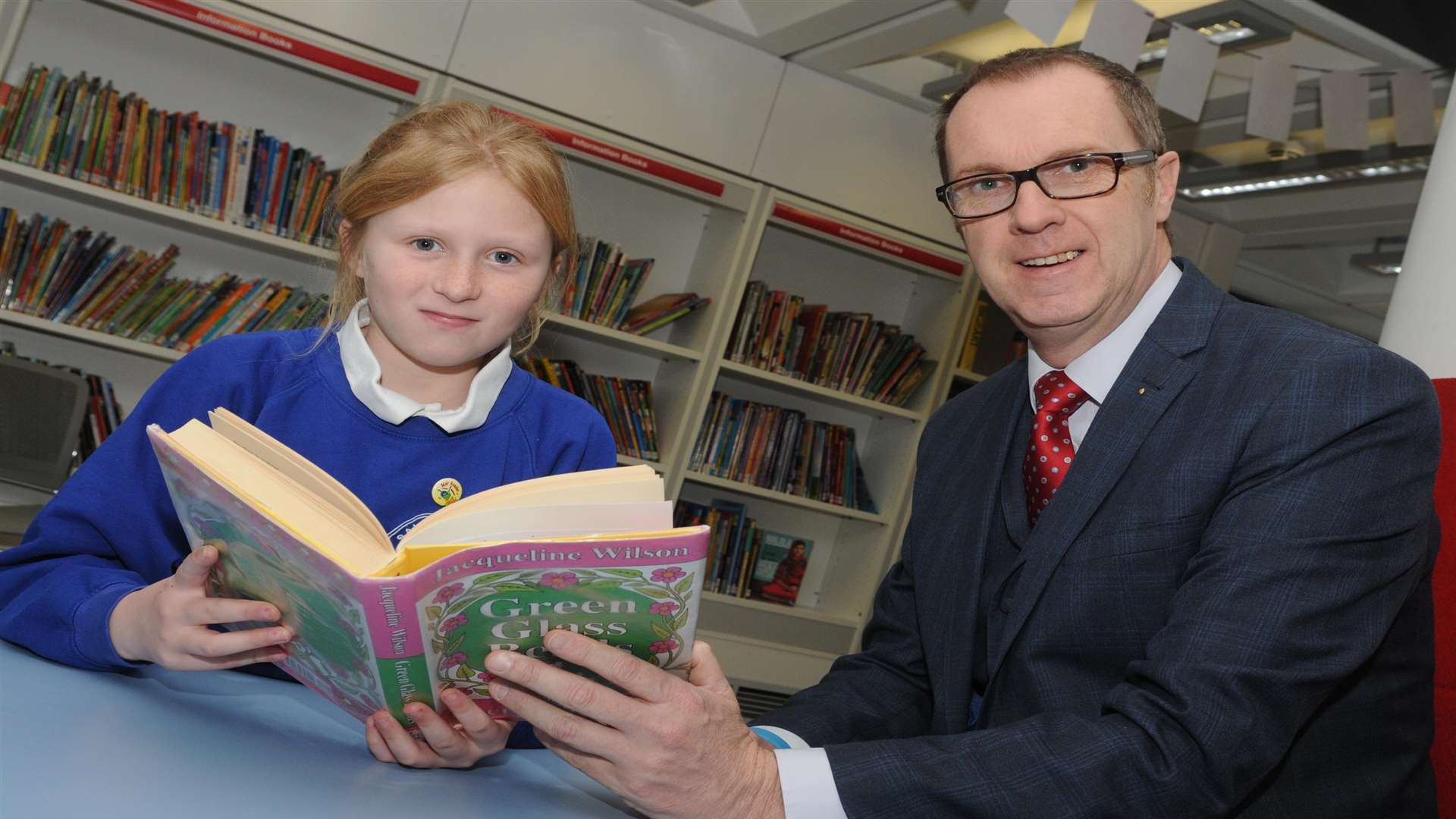 Taylor Lloyd at Canterbury Library with Robin Evans from Clarkson Wright and Jakes Ltd which is a key partner of the Kent Literacy Awards.