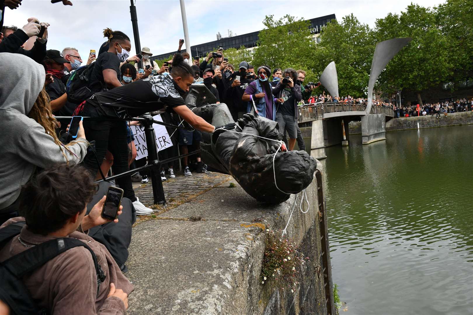 Protesters throw statue of Edward Colston into Bristol harbour (PA)