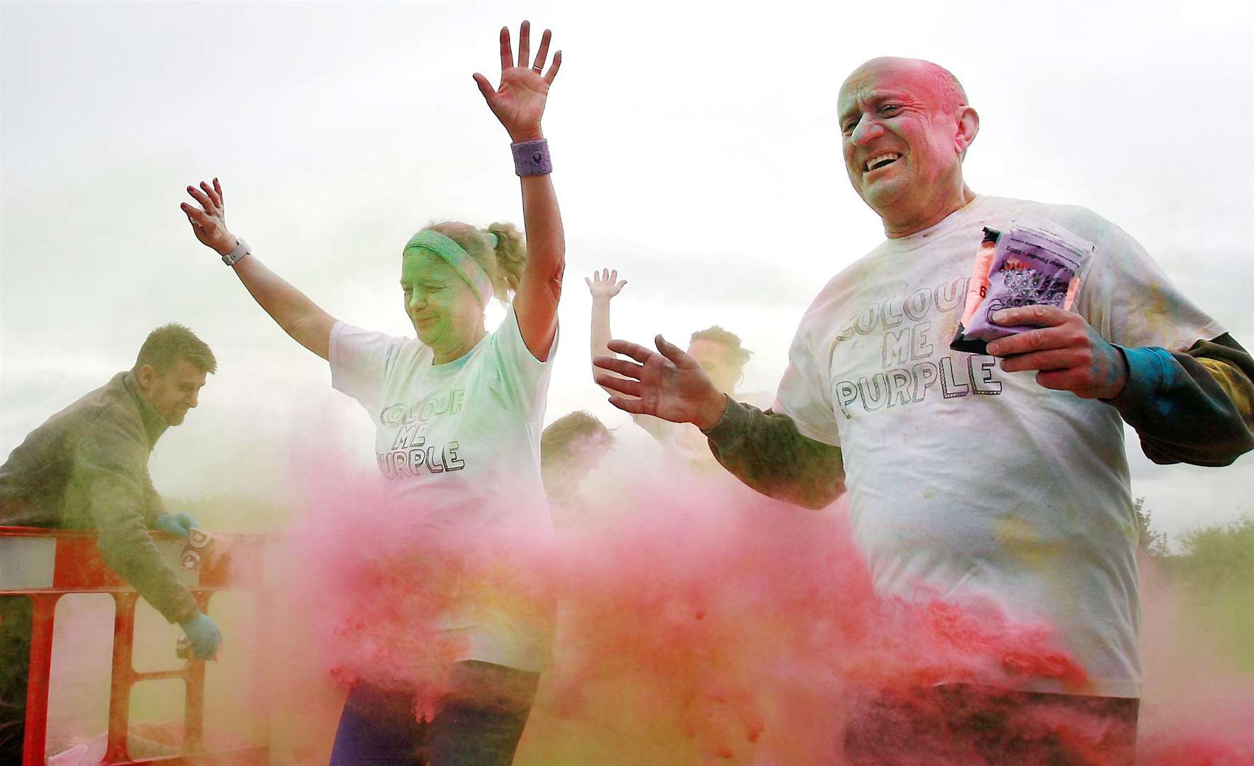 Competitors are pelted with coloured dye during the Colour Me Purple 5km run through Milton Creek Country Park for the Wisdom Hospice. Picture: Phil Lee