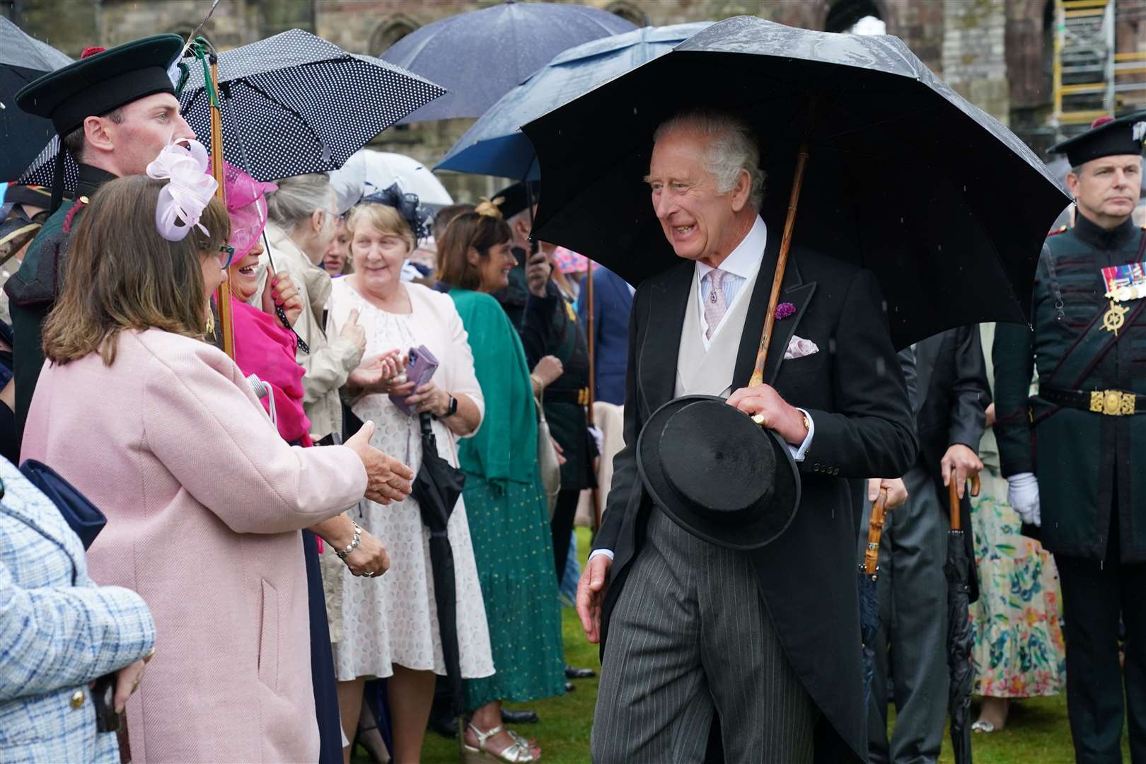 The King greets guests during a Garden Party at the Palace of Holyroodhouse in Edinburgh as part of the first Holyrood Week since the King’s coronation (Jonathan Brady/PA)