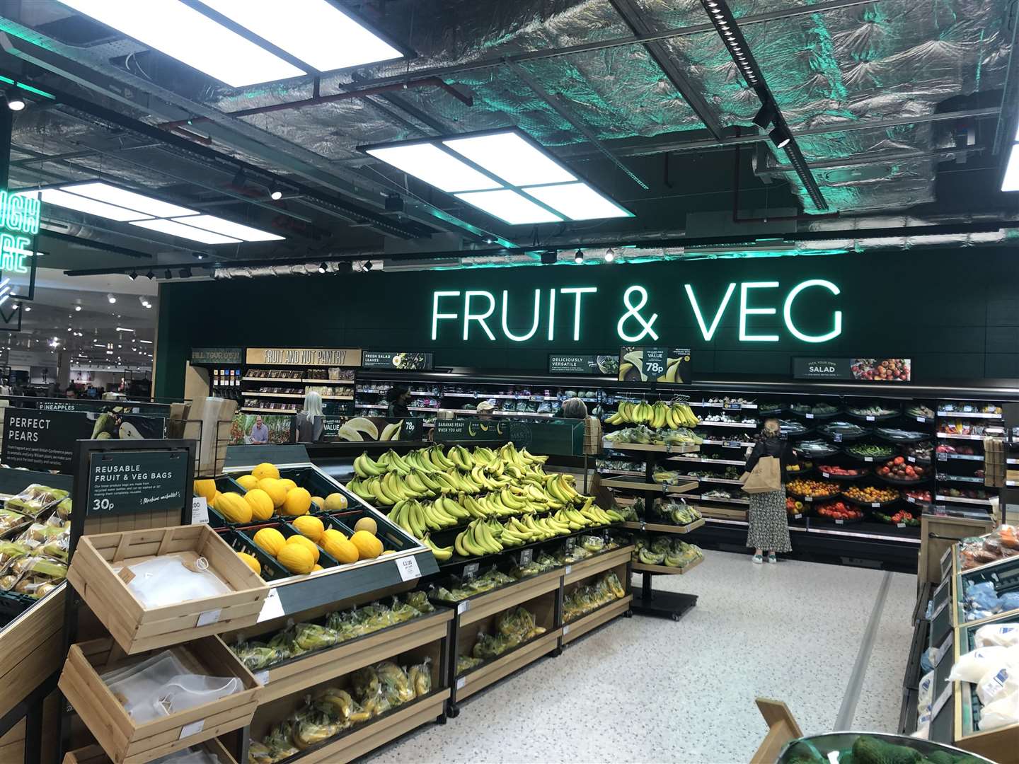 There are neon signs above some sections of the shop