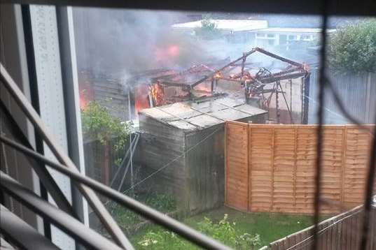 The fire seen through a window, photo by Nicola Read