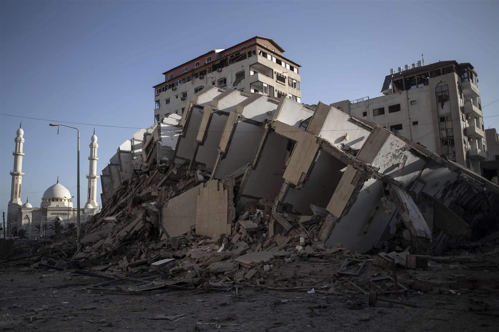 The remains of a building destroyed by Israeli air strikes on Gaza City (Khalil Hamra/AP)