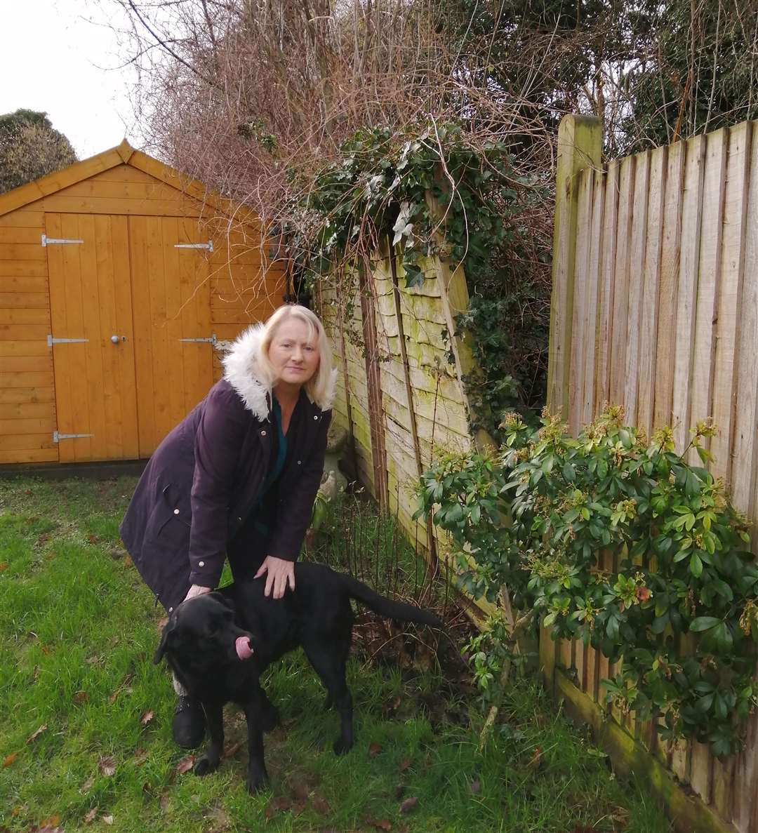 Vanessa McCloud with Evie by the damaged fence