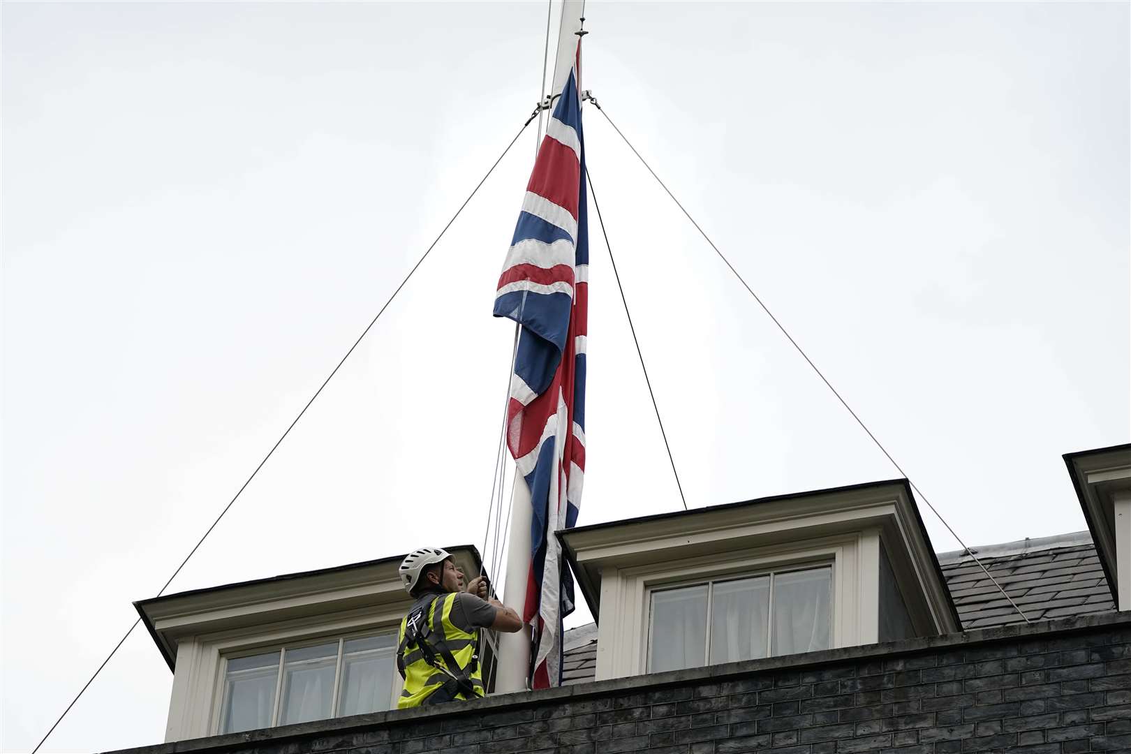 The Union flags above Downing Street have been lowered to half mast (Aaron Chown/PA)