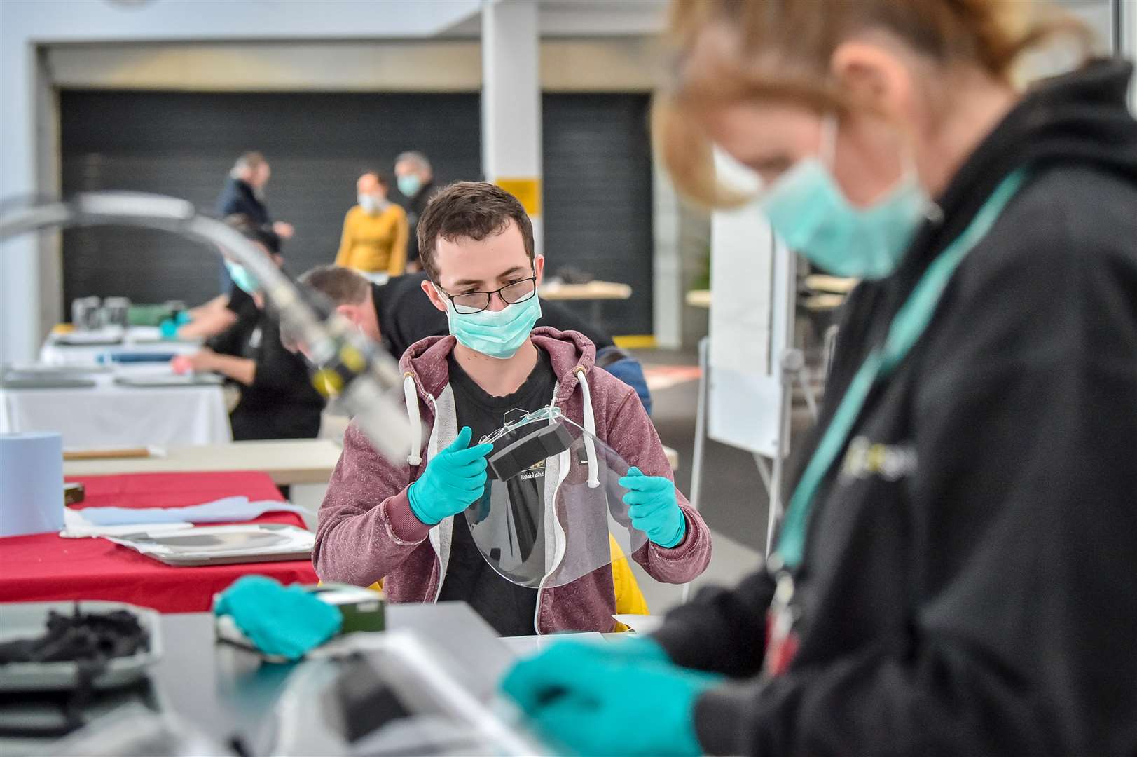 Royal Mint employees assemble full face visors (Ben Birchall/PA)