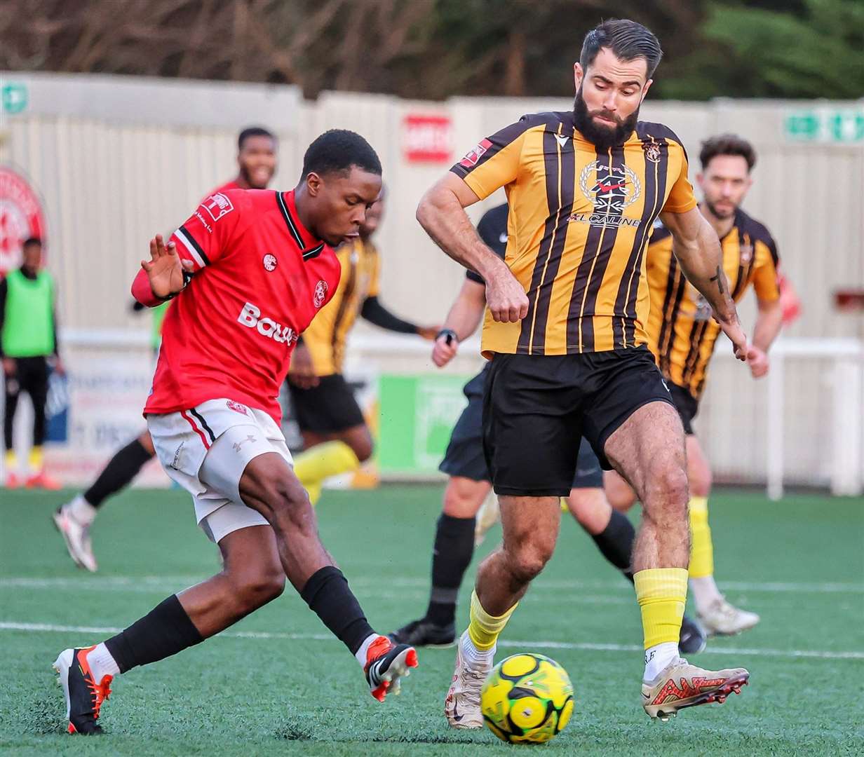 Joe Turner, of Folkestone, tracks Chatham defender Miguel Scarlett. Picture: Helen Cooper