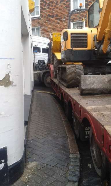 Lorry transporting a digger stuck in Strand Street in Sandwich