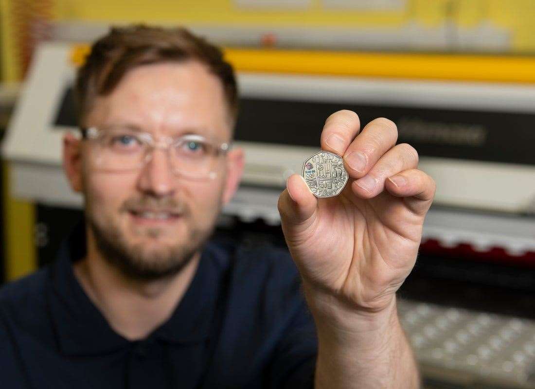 Royal Mint senior designer David Knapton holding a commemorative 50p coin (Royal Mint/PA)