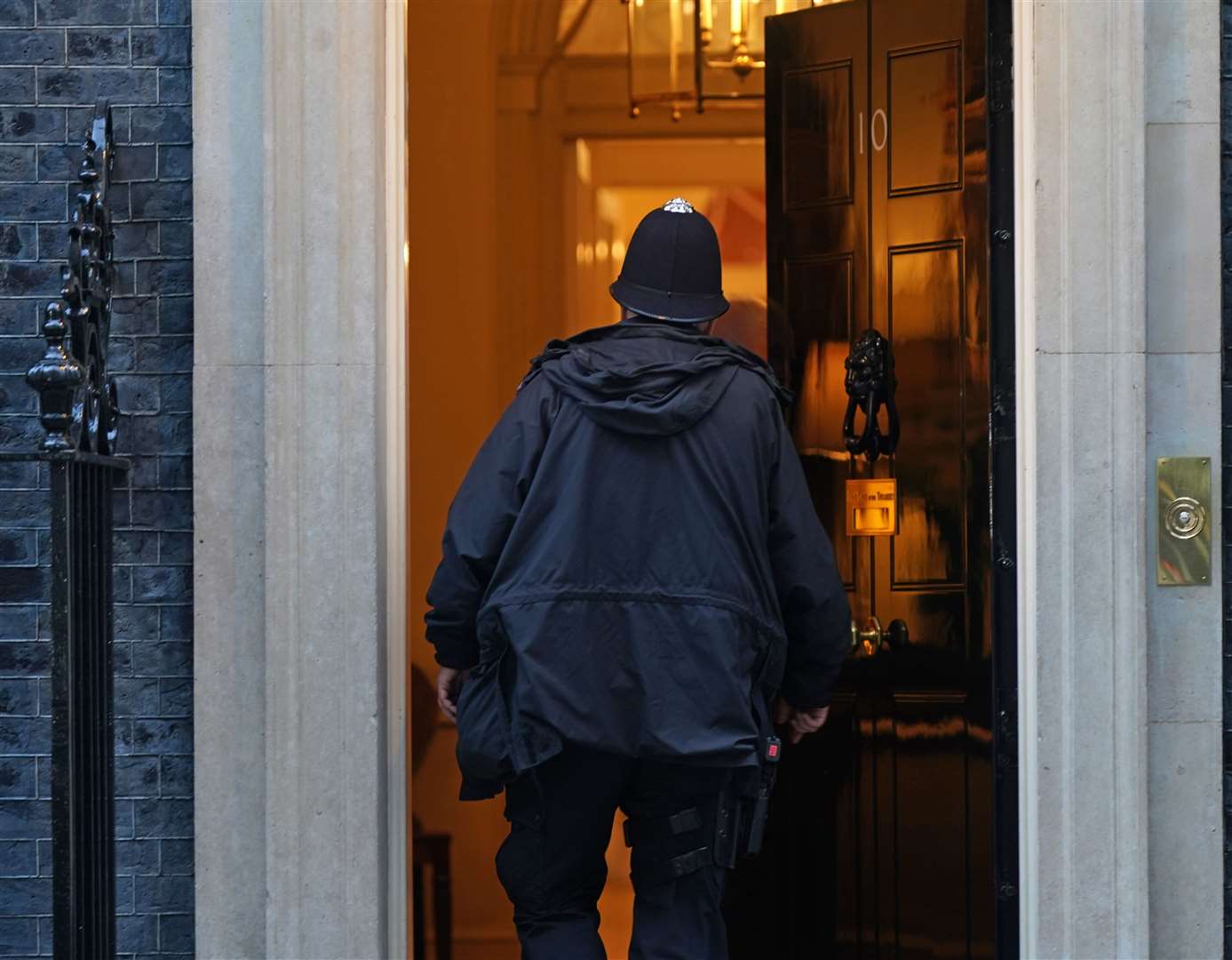 A police officer enters 10 Downing Street in Westminster (Yui Mok/PA)