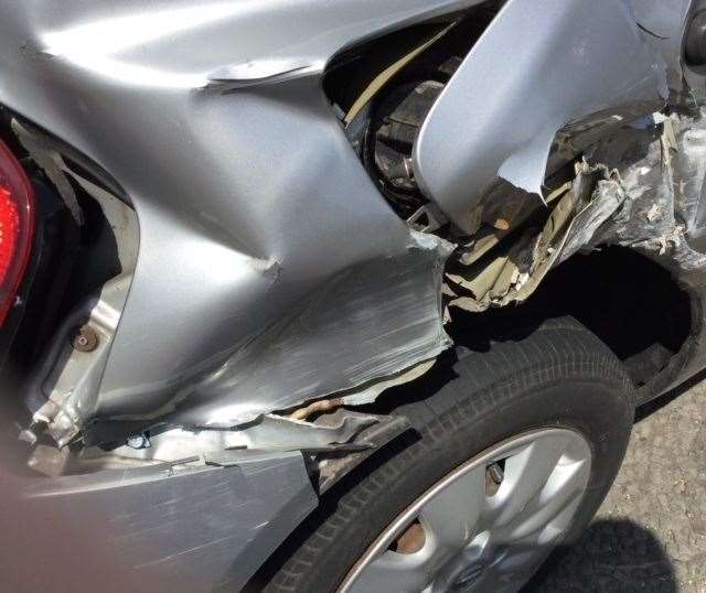 Crunched wreckage of parked car