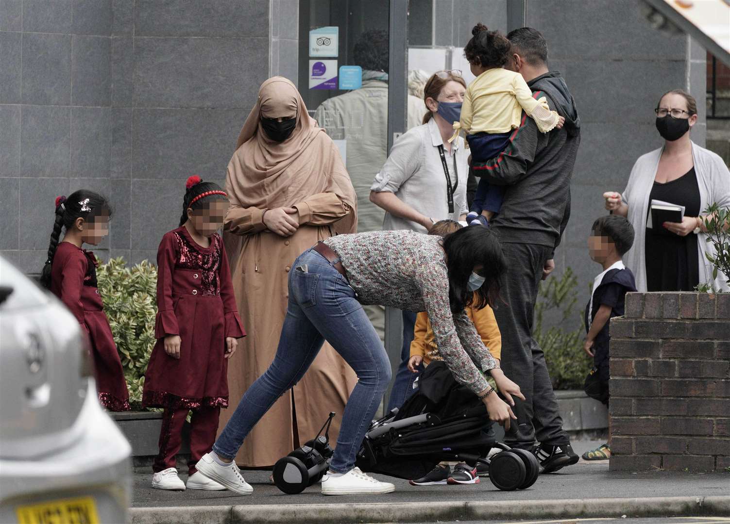 People leave the Sheffield Metropolitan Hotel, where a young Afghan refugee died after he fell from a window (Peter Byrne/PA)