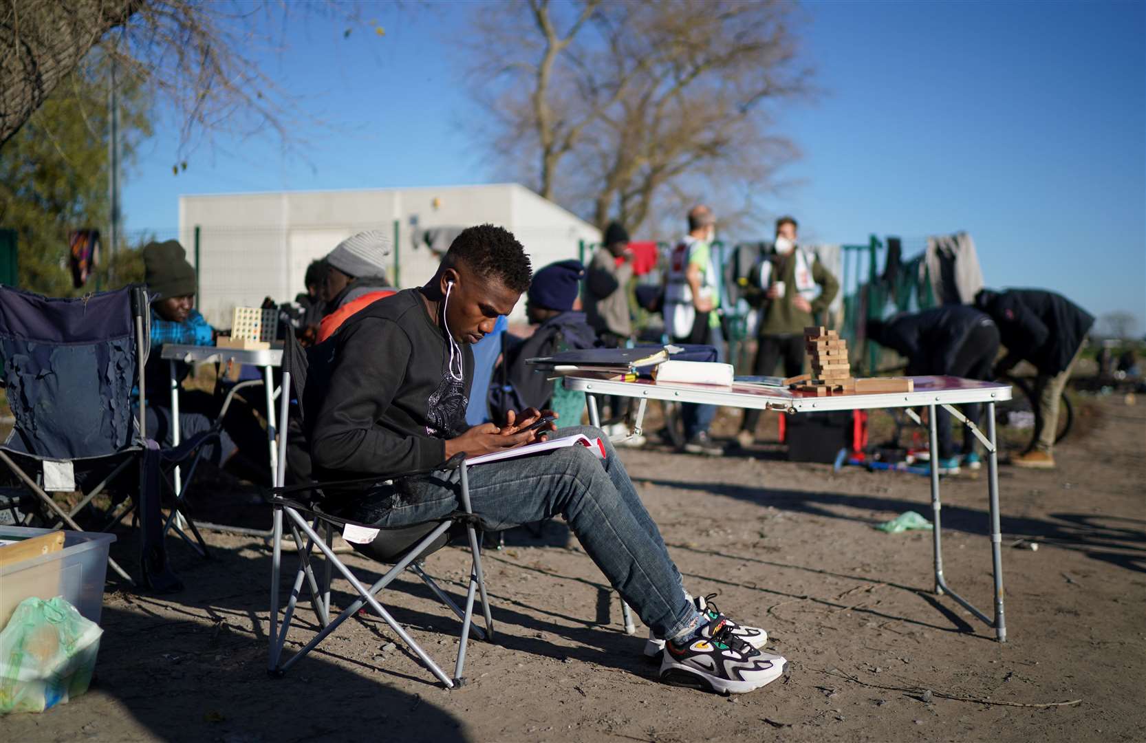 A man studies at the makeshift Calias camp (Gareth Fuller/PA)