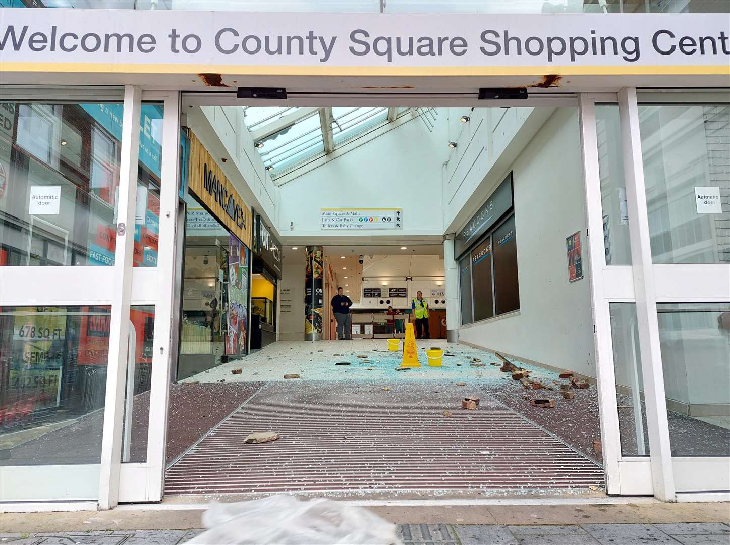 Glass and bricks on the floor at the Tufton Street entrance on Friday