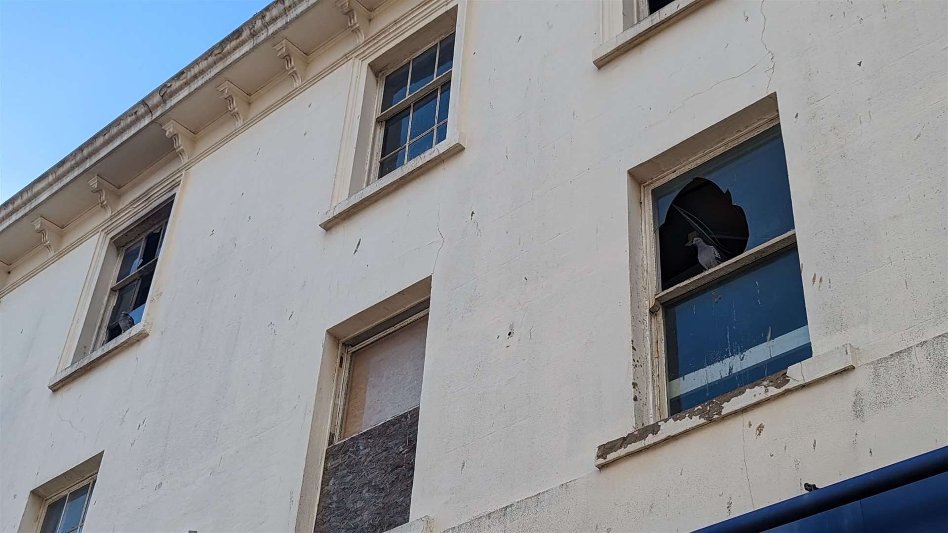 The ex-clothes shop boasts smashed and boarded up windows and is covered in graffiti