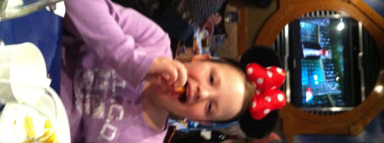Rachel wears Minnie Mouse ears at Disneyland