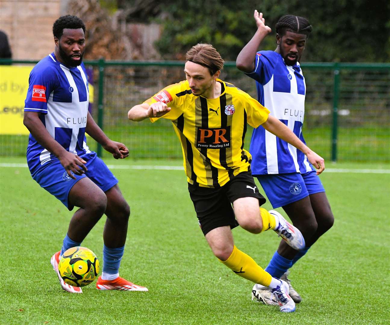 Sheppey United's Jacob Lambert tussles for the loose ball with Herne Bay midfielder Mo Kamara. Picture: Marc Richards