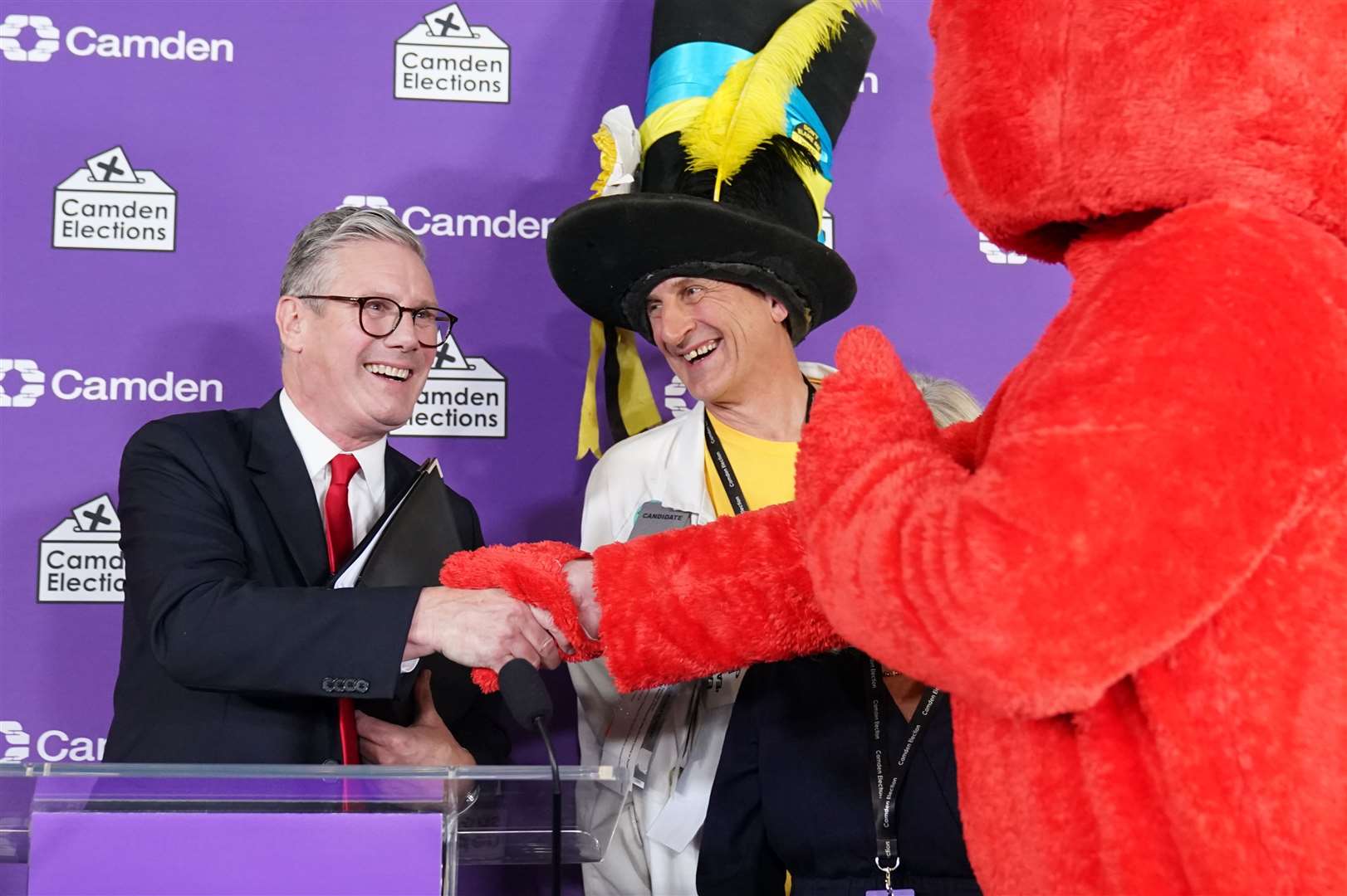 Labour leader Sir Keir Starmer shakes hands with Nick the Incredible Flying Brick (second right) and Bobby “Elmo” Smith (right) at the headquarters of Camden Council (Stefan Rousseau/PA)