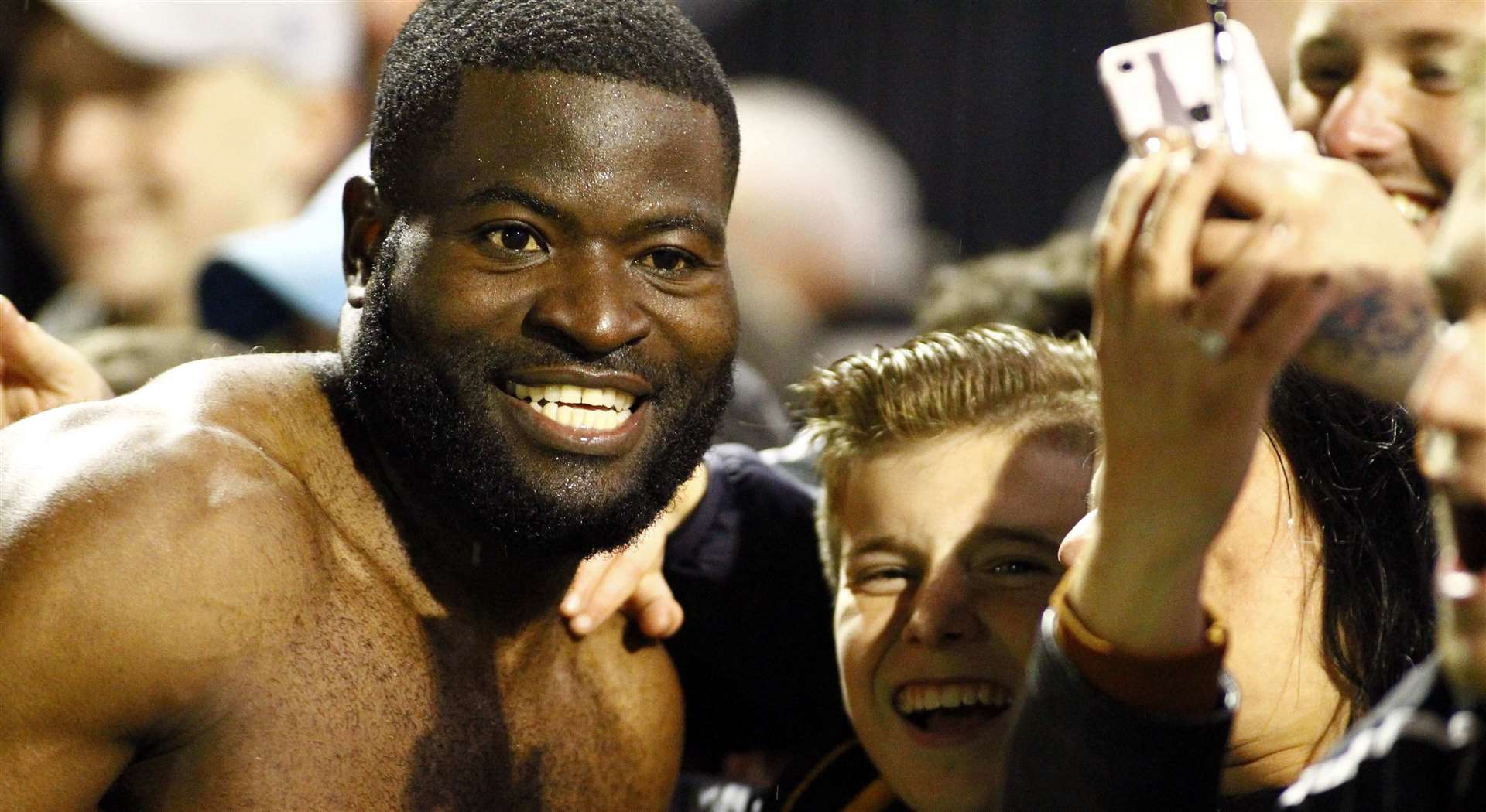 Captain George Elokobi celebrates with fans after Maidstone reach the second round Picture: Sean Aidan
