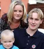 LIFESAVER: retained fireman Lee Ashdown with his partner, Merren, and their son Jamie. Picture: MIKE WATERMAN