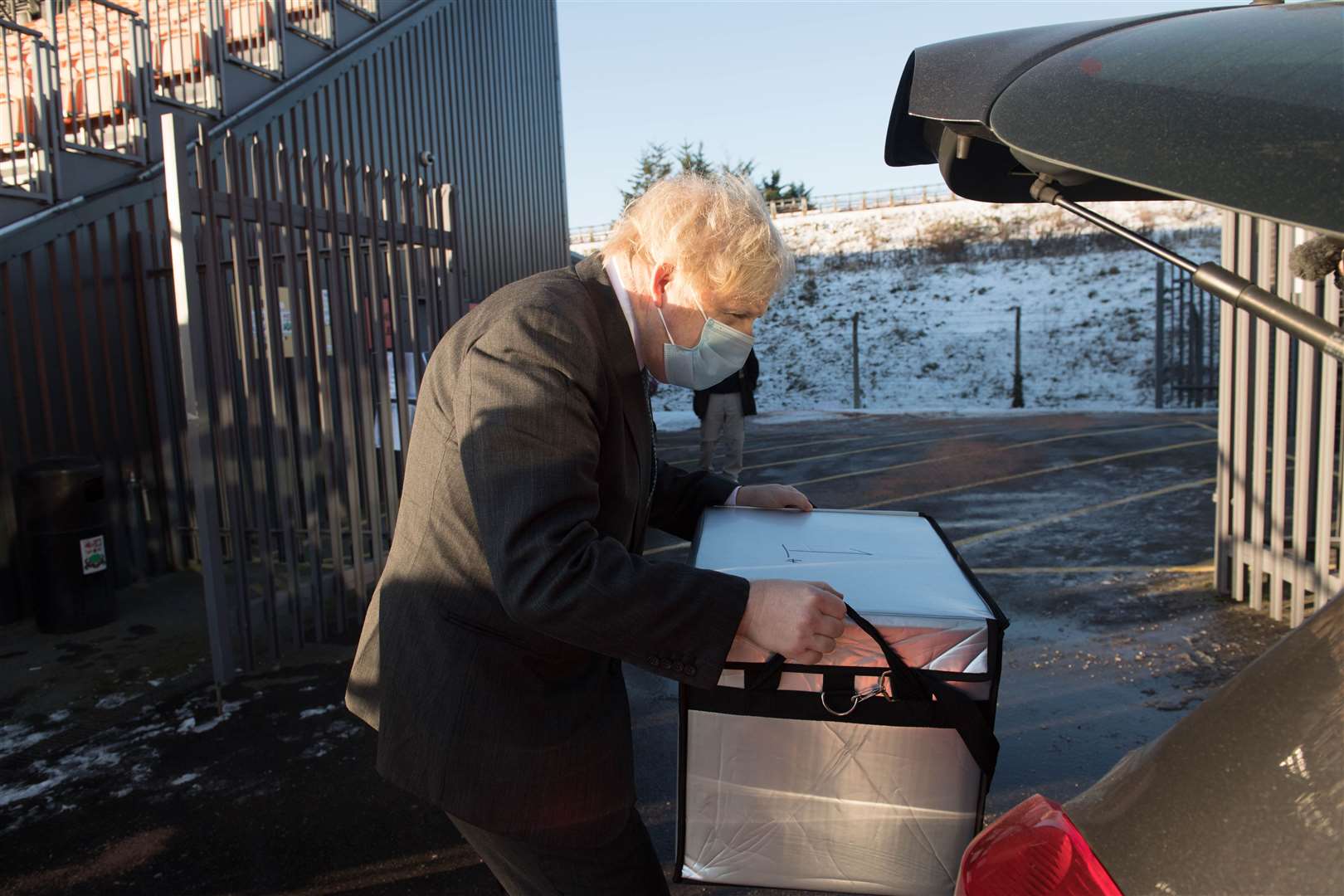 Boris Johnson loads doses of the Oxford/Astrazeneca coronavirus vaccine for mobile distribution at Barnet FC’s ground, The Hive (Stefan Rousseau/PA)