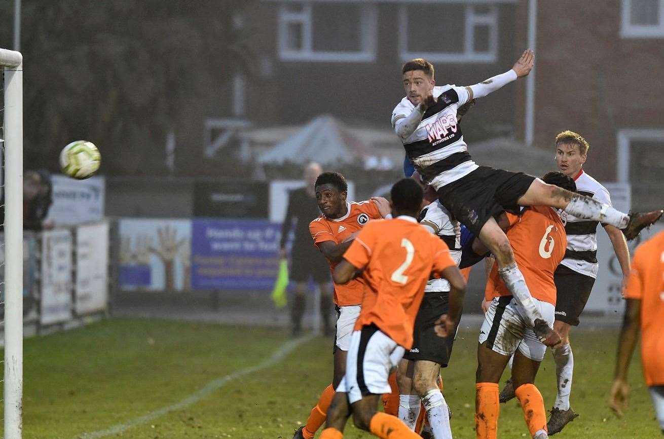 Billy Munday rises high to head home Deal's second goal in their 4-1 win over Fisher. Picture: Tony Flashman