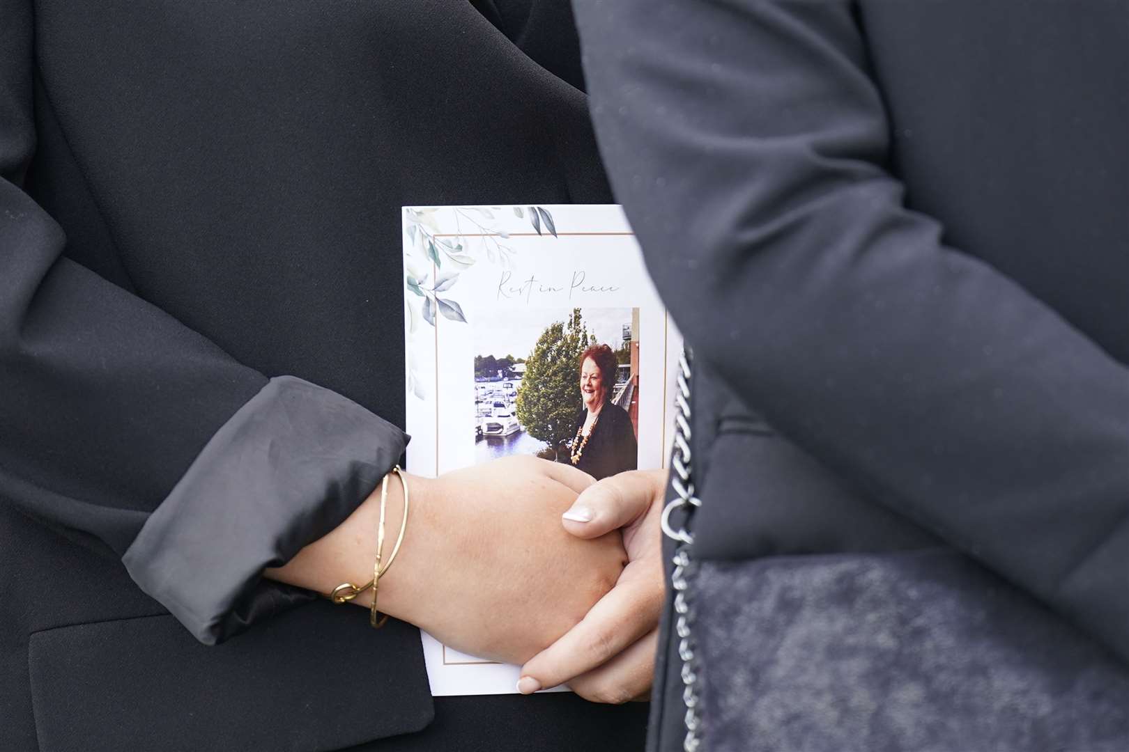 A mourner holds an Order of Service (Niall Carson/PA)