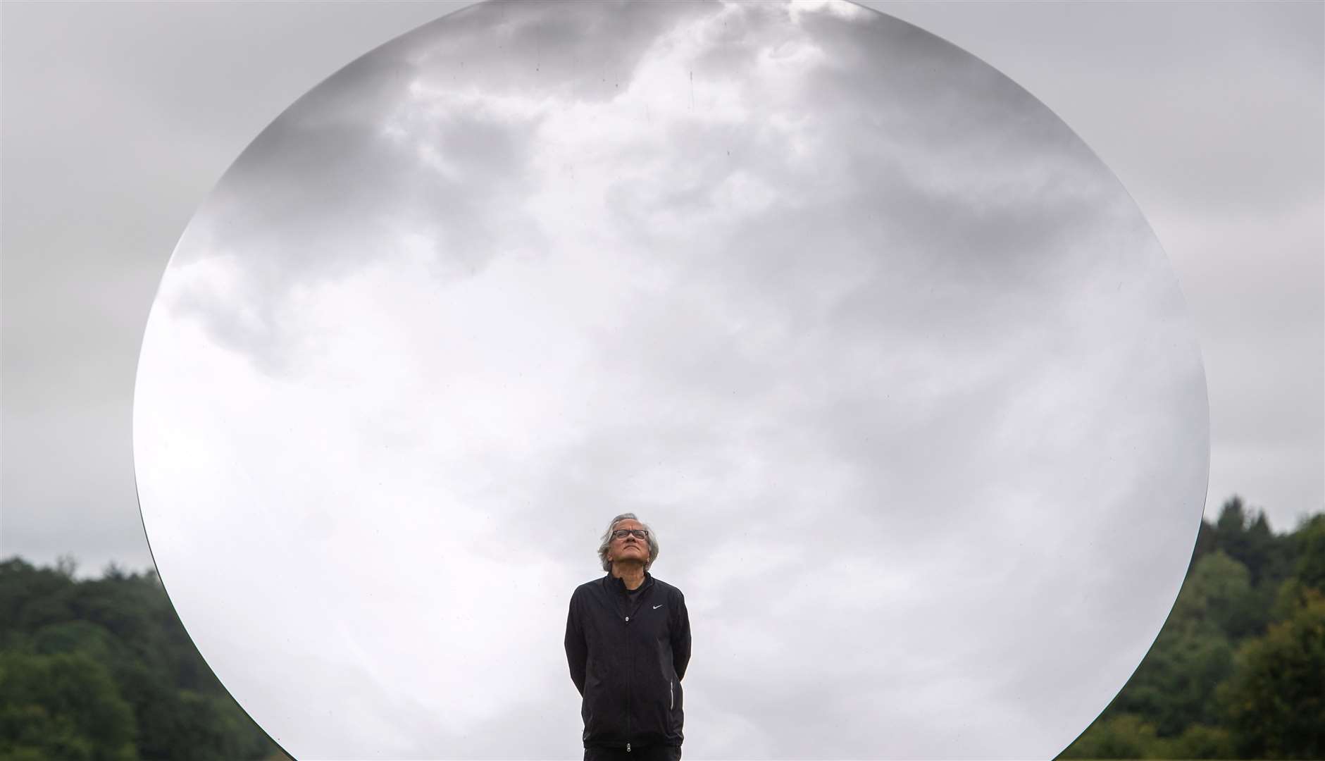 Artist Sir Anish Kapoor stands in front of Sky Mirror at Houghton Hall (Joe Giddens/PA)