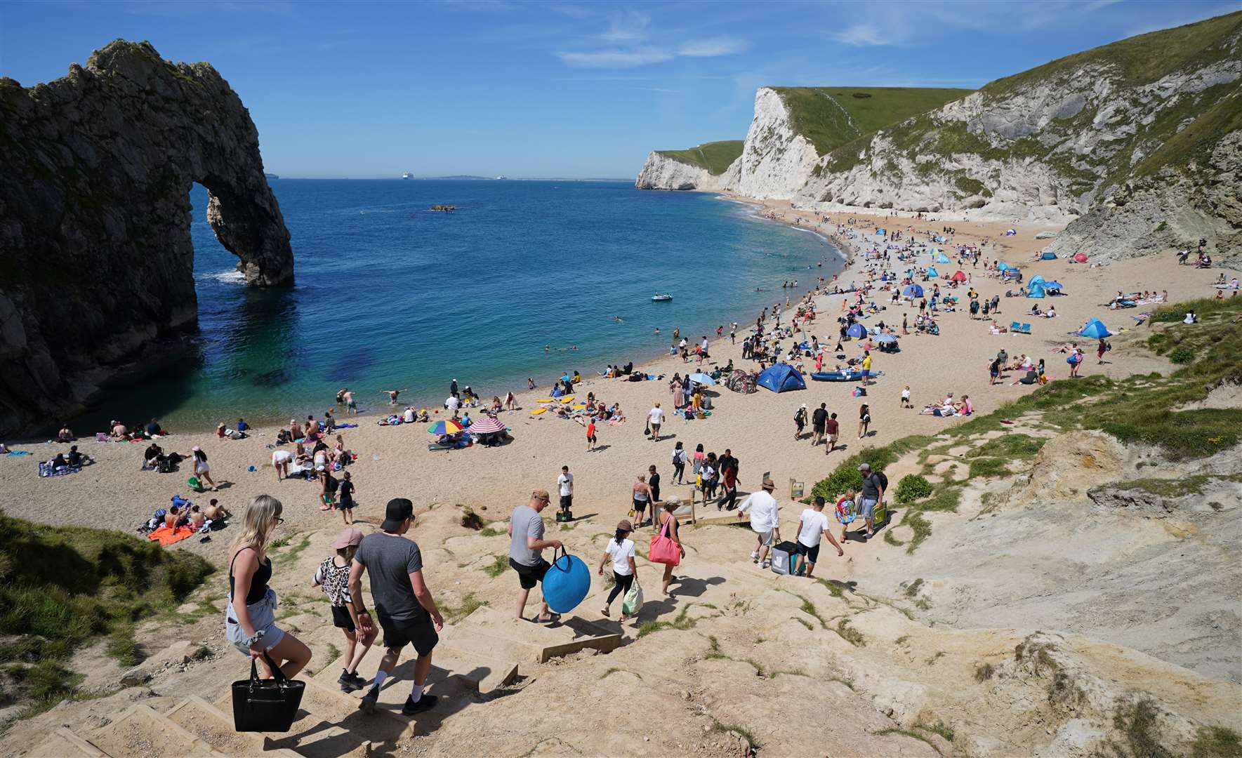 People make their way down to the beach at Durdle Door in Dorset (Andrew Matthews/PA)