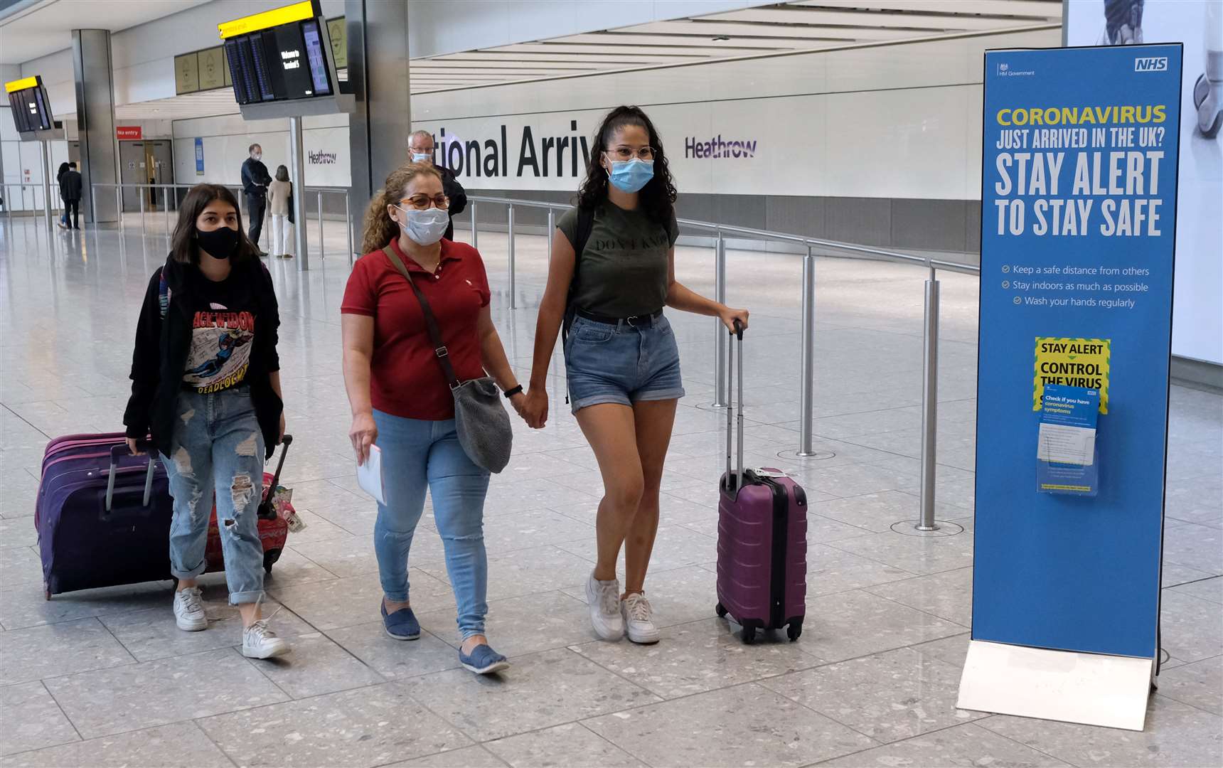 Passengers on a flight at Heathrow Airport (PA)