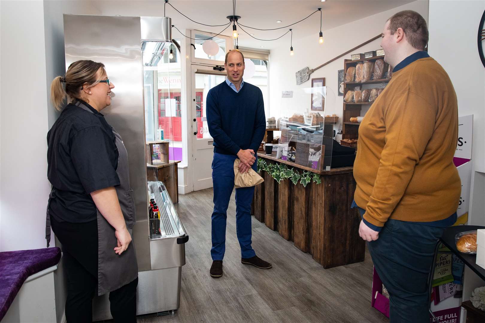 The duke meets shop staff Sarah Easthall and Ted Bartram (Aaron Chown/PA)