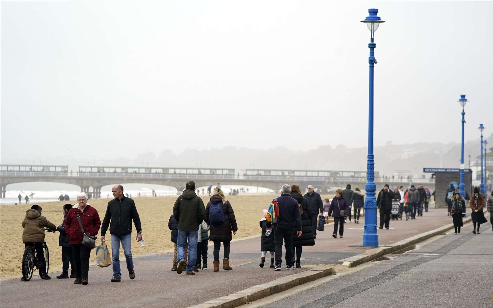 People walk along the sea front in Bournemouth (PA)