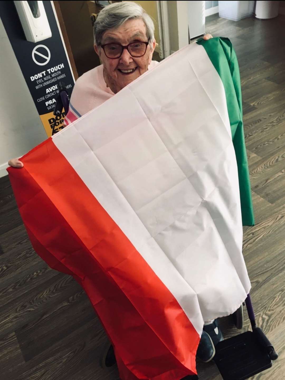 Centenarian Marj Guard models the Italian flag as she disembarks the virtual cruise liner