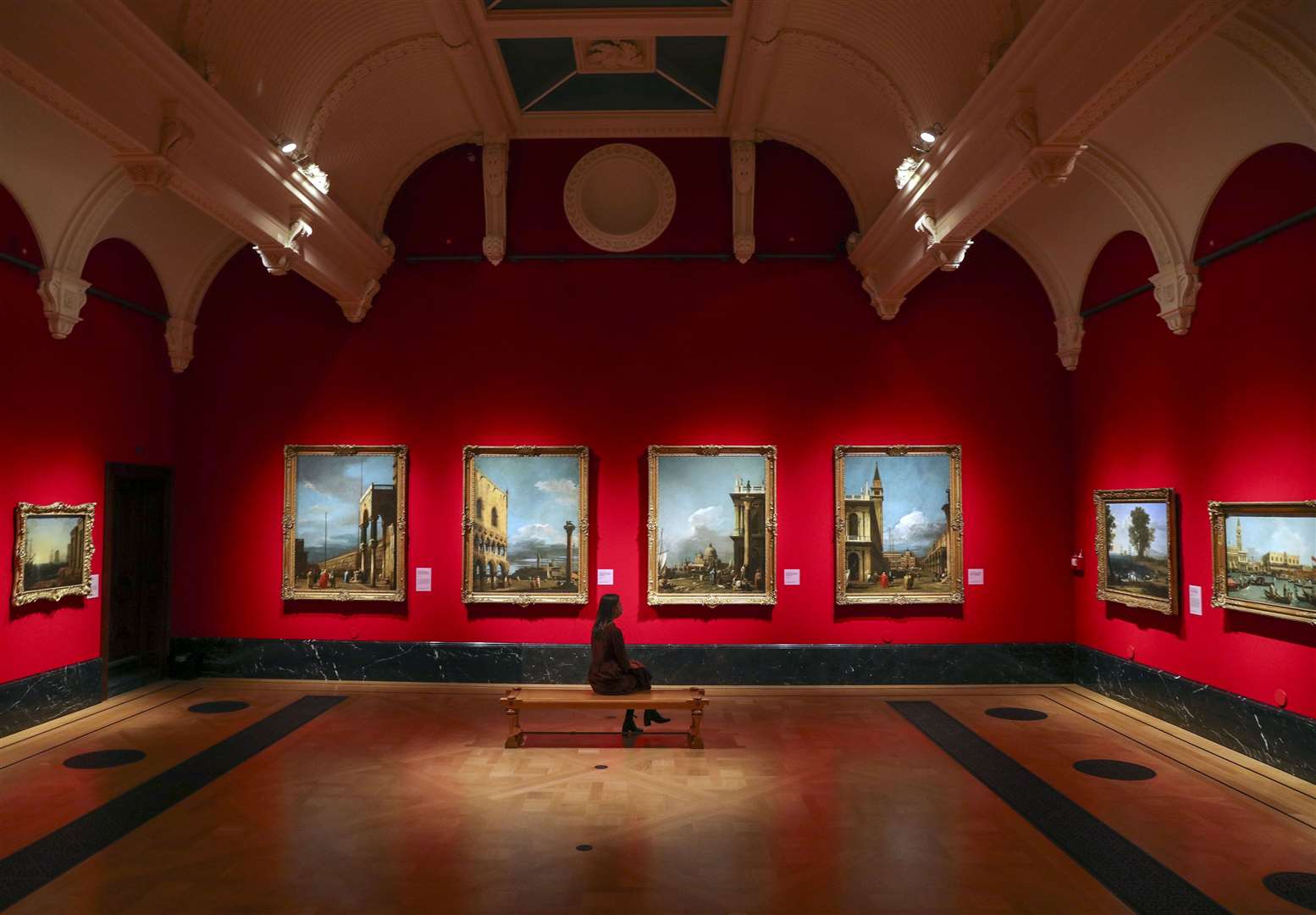 A woman looks at paintings by the Italian artist Canaletto (Steve Parsons/PA)