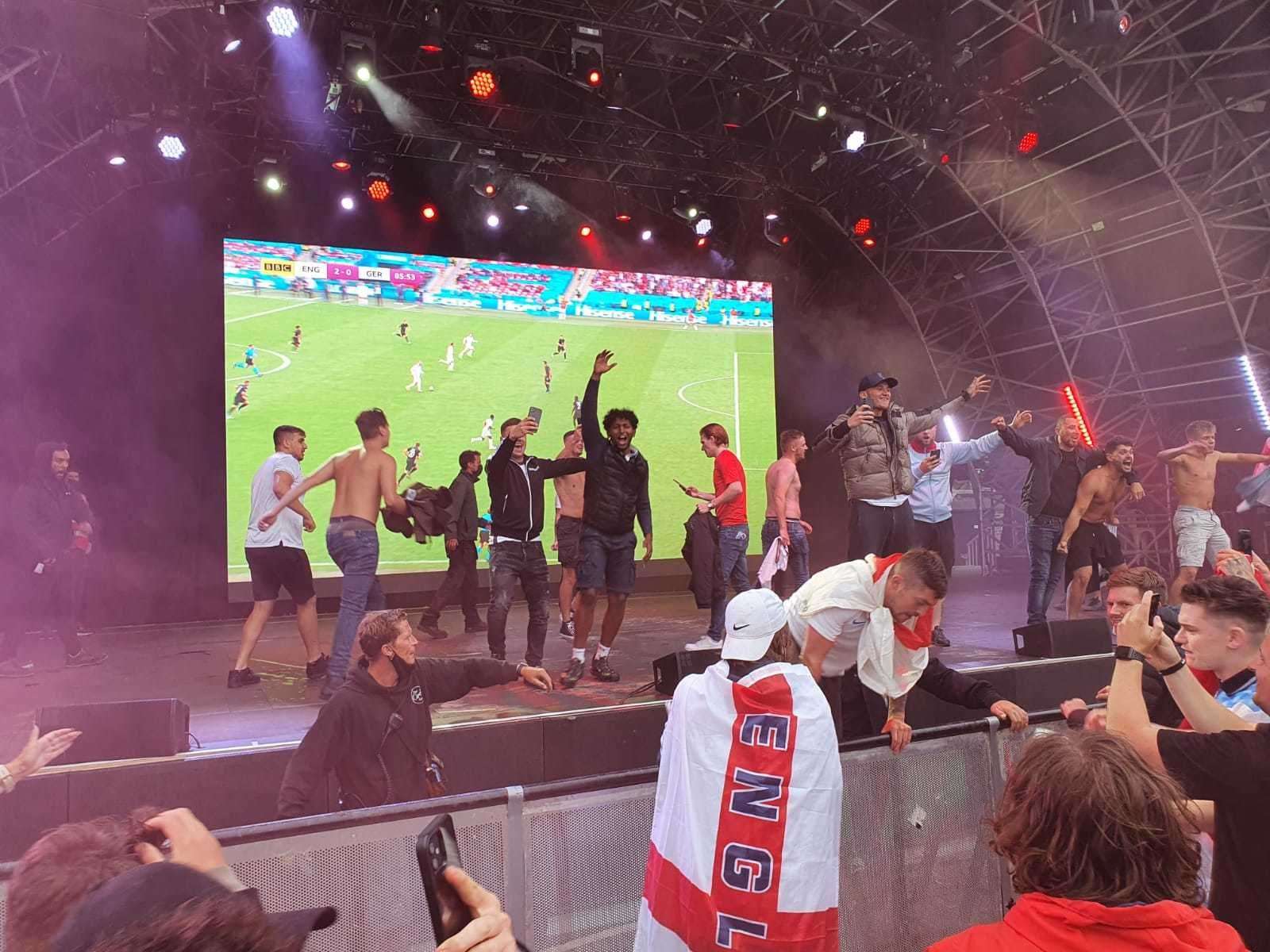 Fans climbed railings to get on the stage after England doubled their lead