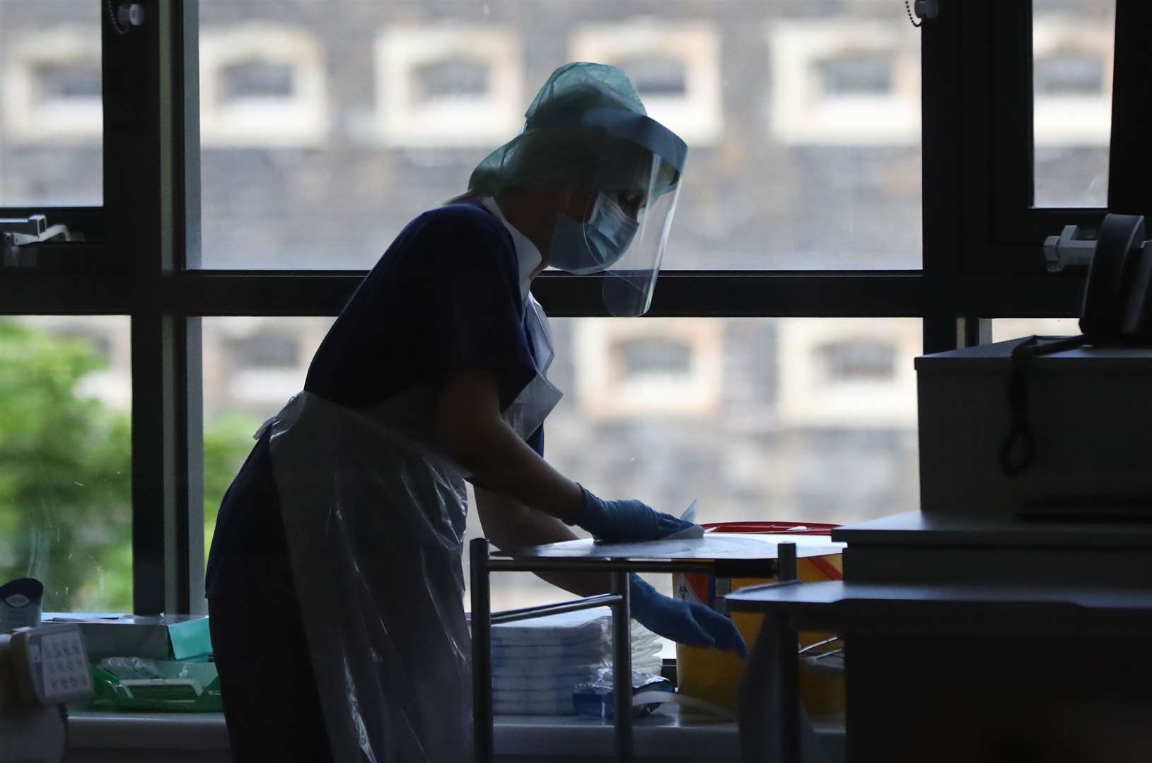 A nurse disinfects work surfaces at the Mater Hospital Covid-19 recovery ward in Belfast (Niall Carson/PA)