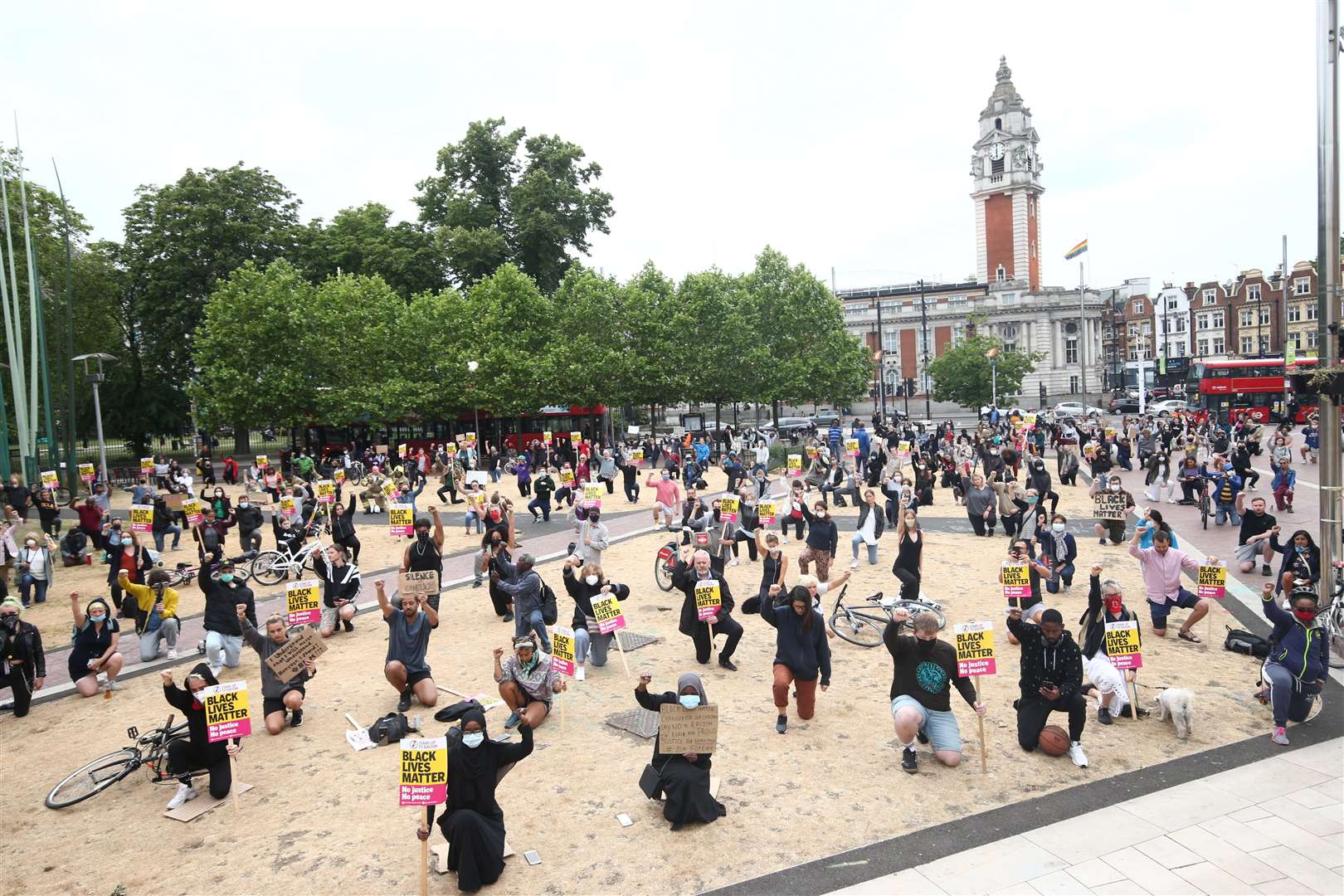 People kneel during a Black Lives Matter protest rally at Windrush Square, Brixton (Yui Mok/PA)