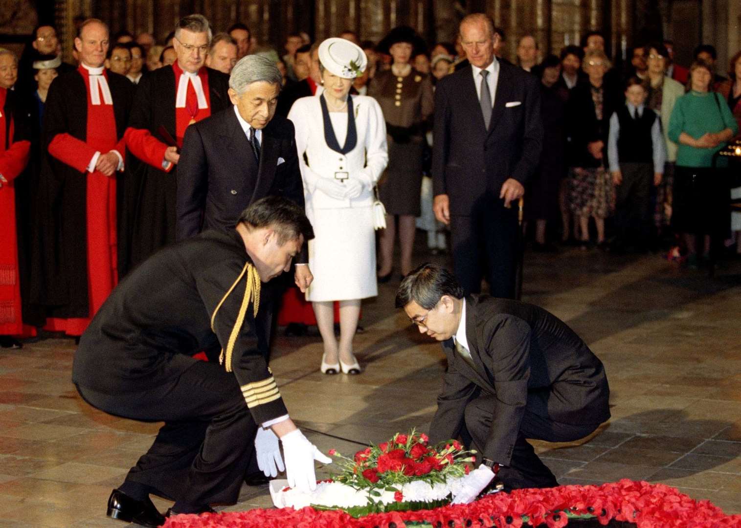 Japanese Emperor Akihito watches as a wreath is laid on his behalf in 1998 (PA)