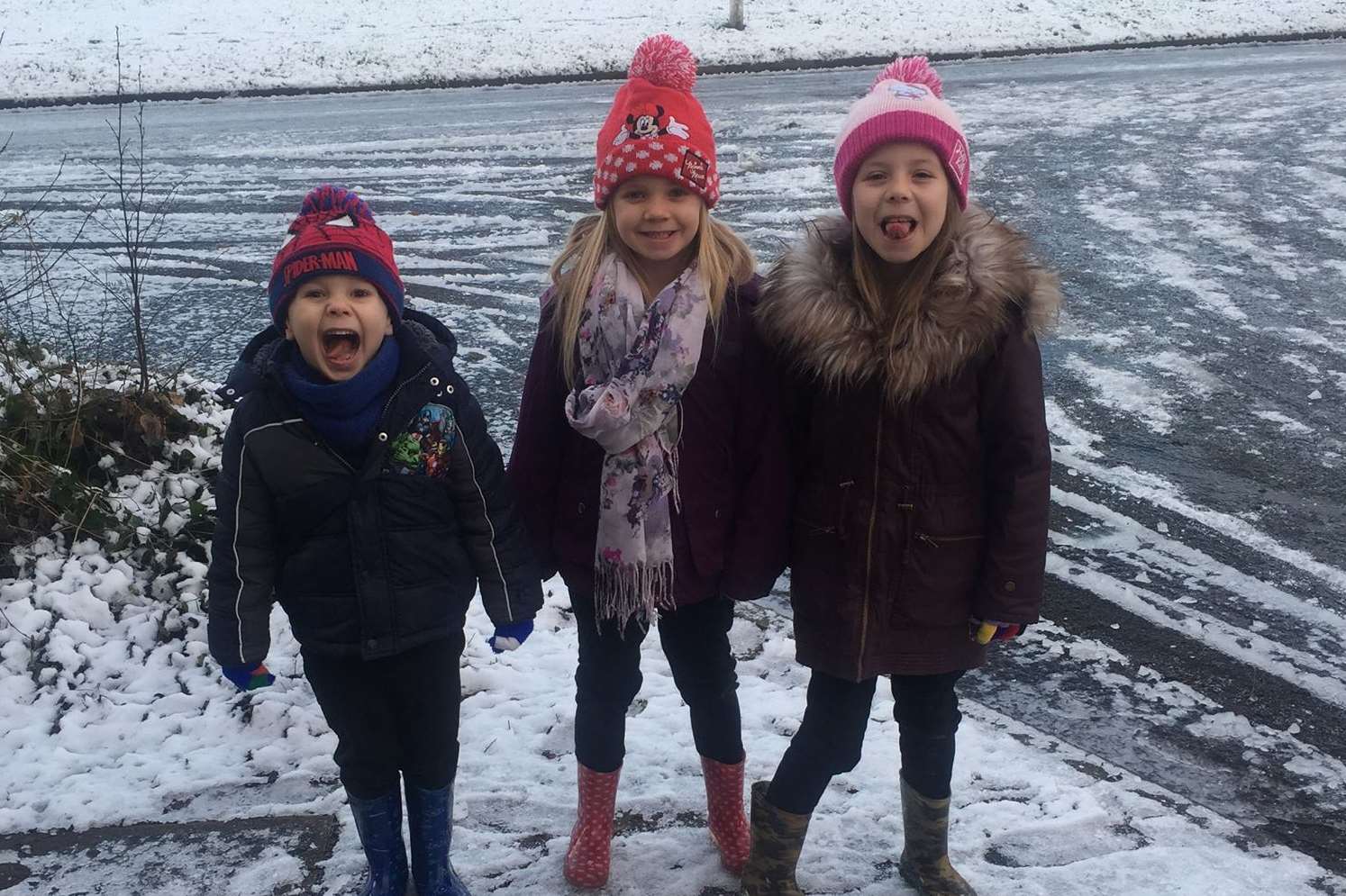 Ruby 7, Lulu, 6, and Marcus Burke, 4, enjoying the snow on the way to school