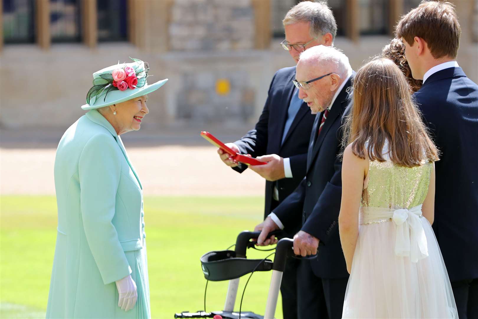 The Queen talking to Captain Sir Tom Moore and his family after awarding his knighthood during a ceremony at Windsor Castle (Chris Jackson/PA)