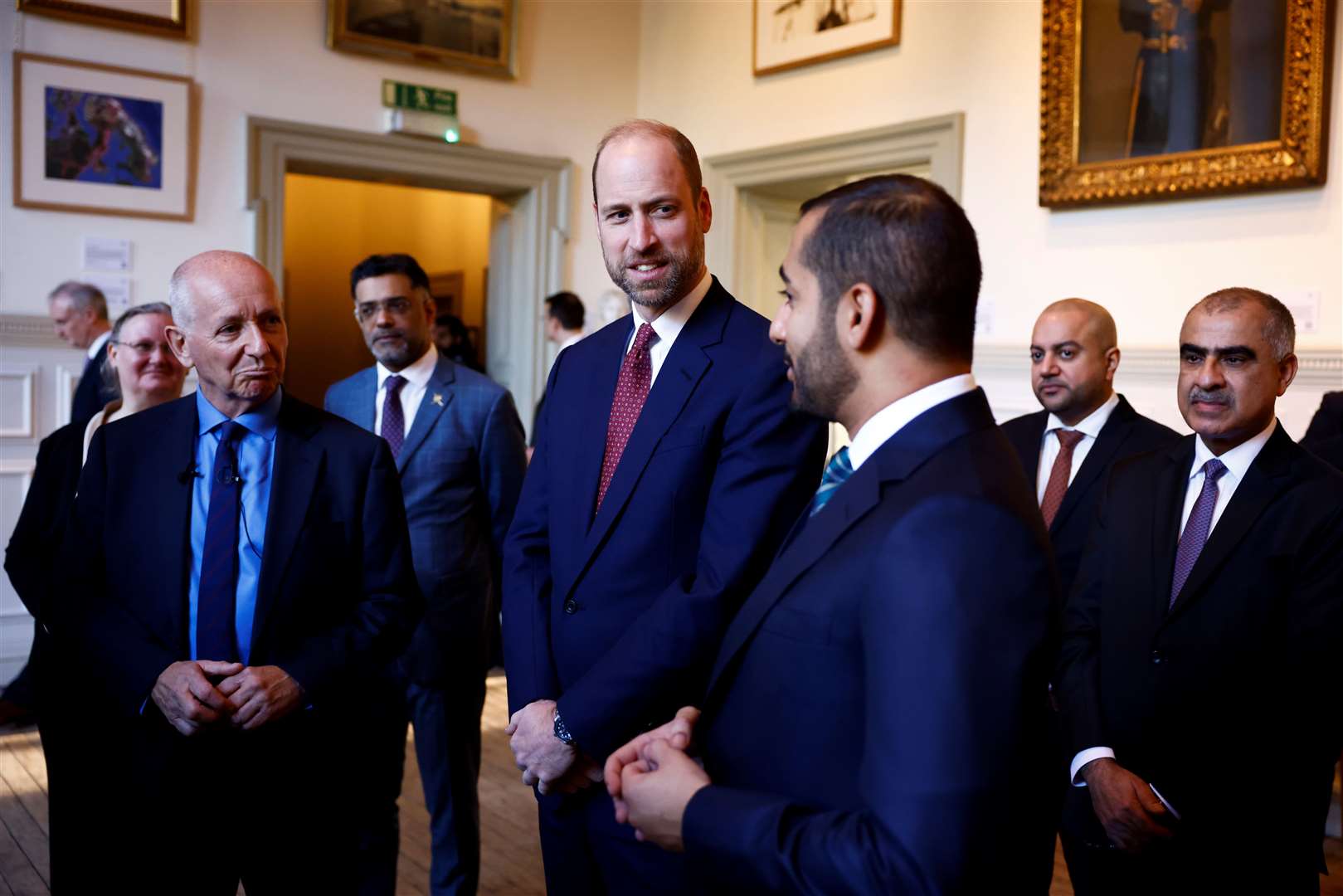 William (centre) and Theyazin bin Haitham listen to British explorer Mark Evans (left) (Benjamin Cremel/PA)