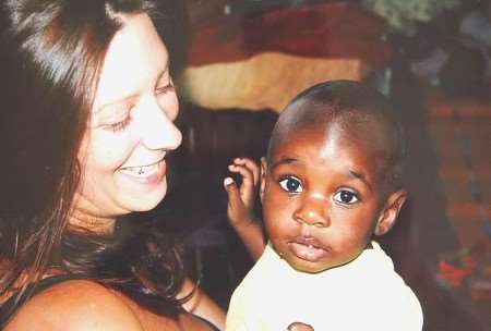 CARING: Debby Holl with one of the orphans, Barbara Namakula. Picture: JIM RANTELL