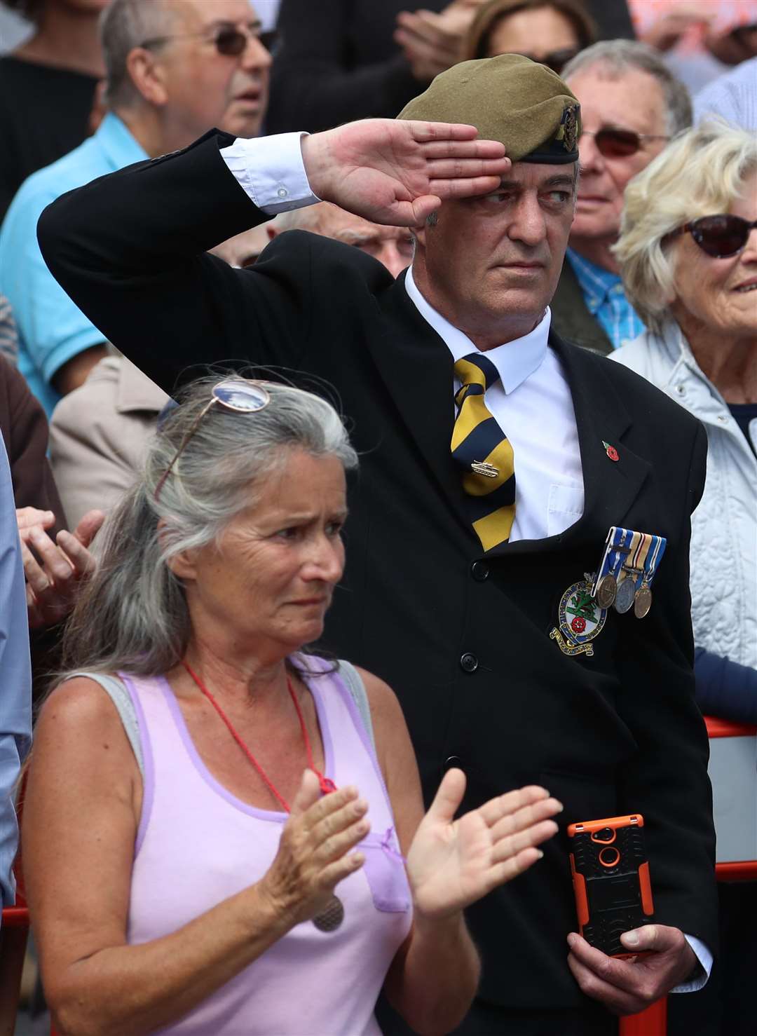 A man salutes the funeral cortege (Gareth Fuller/PA)