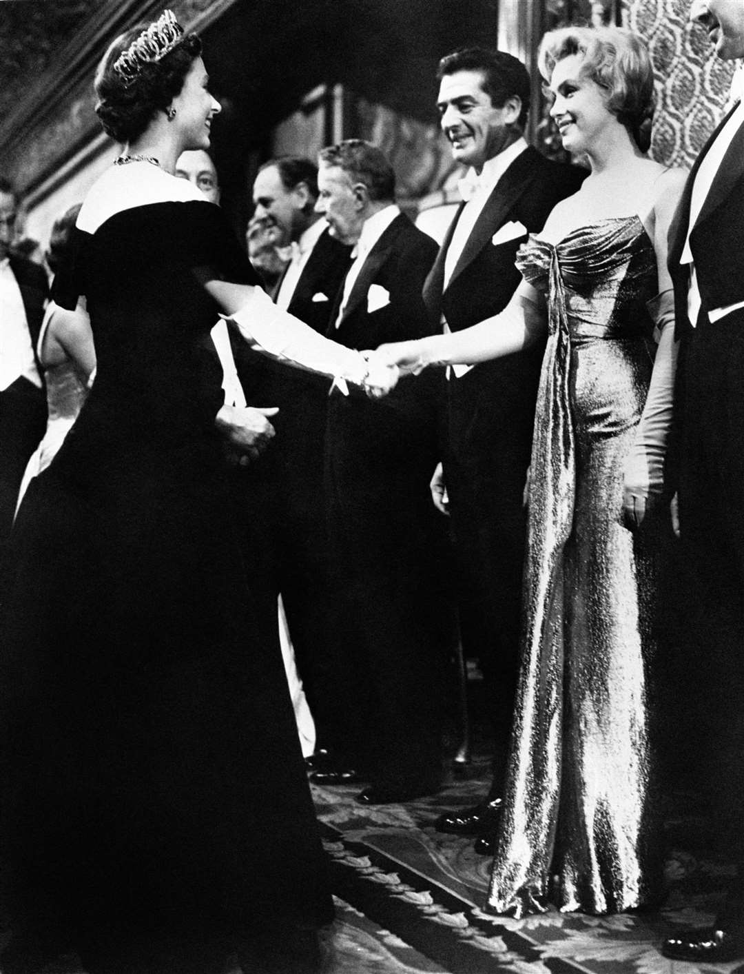 Marilyn Monroe shakes hands with the late Queen at the 1956 Royal Film Performance of The Battle Of The River Plate, at the Empire Theatre, Leicester Square (PA)