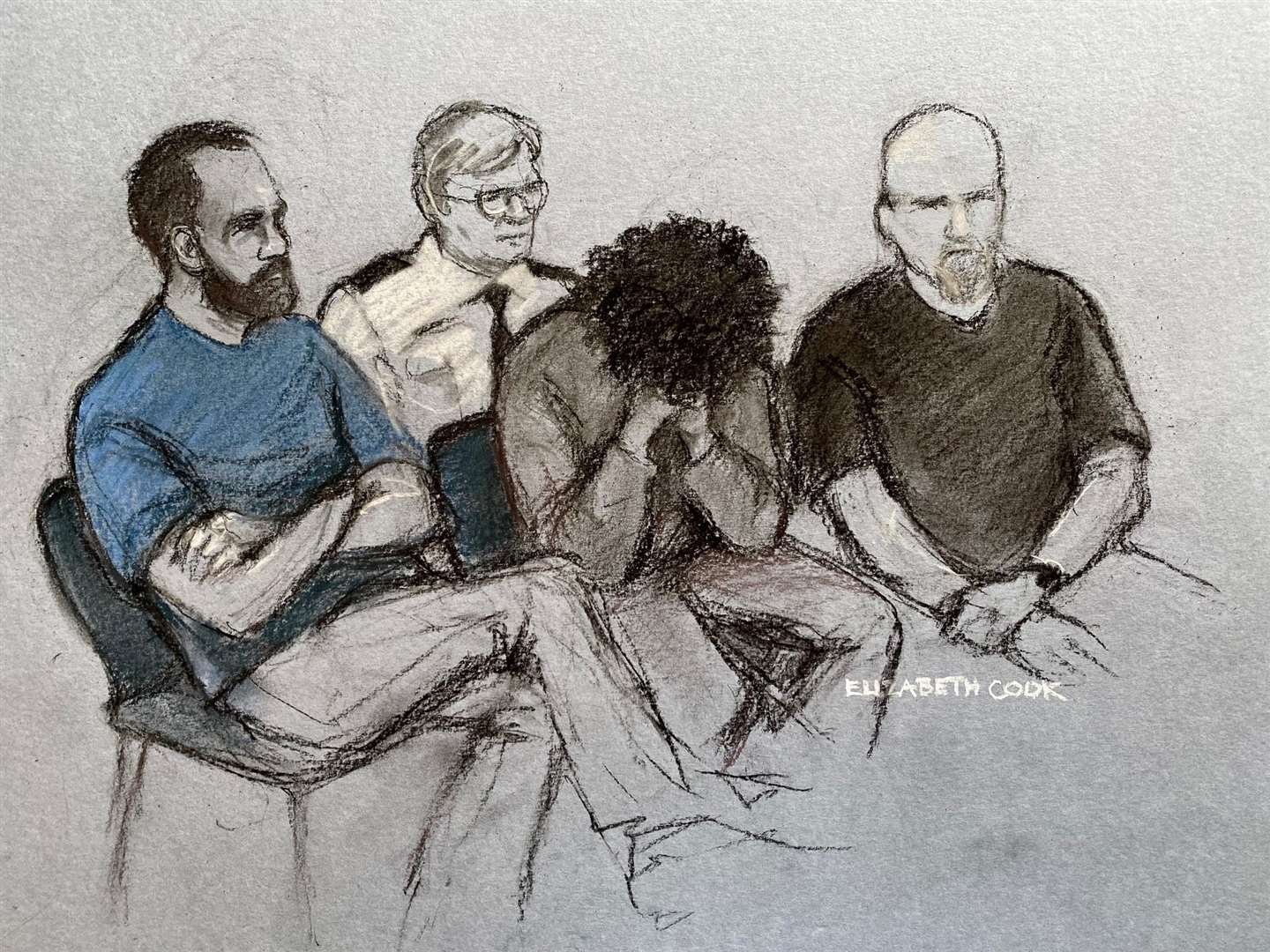 Court artist drawing by Elizabeth Cook of 17-year-old Axel Rudakubana (centre) covering his face as he appeared in the dock at Liverpool Crown Court (Elizabeth Cook/PA)