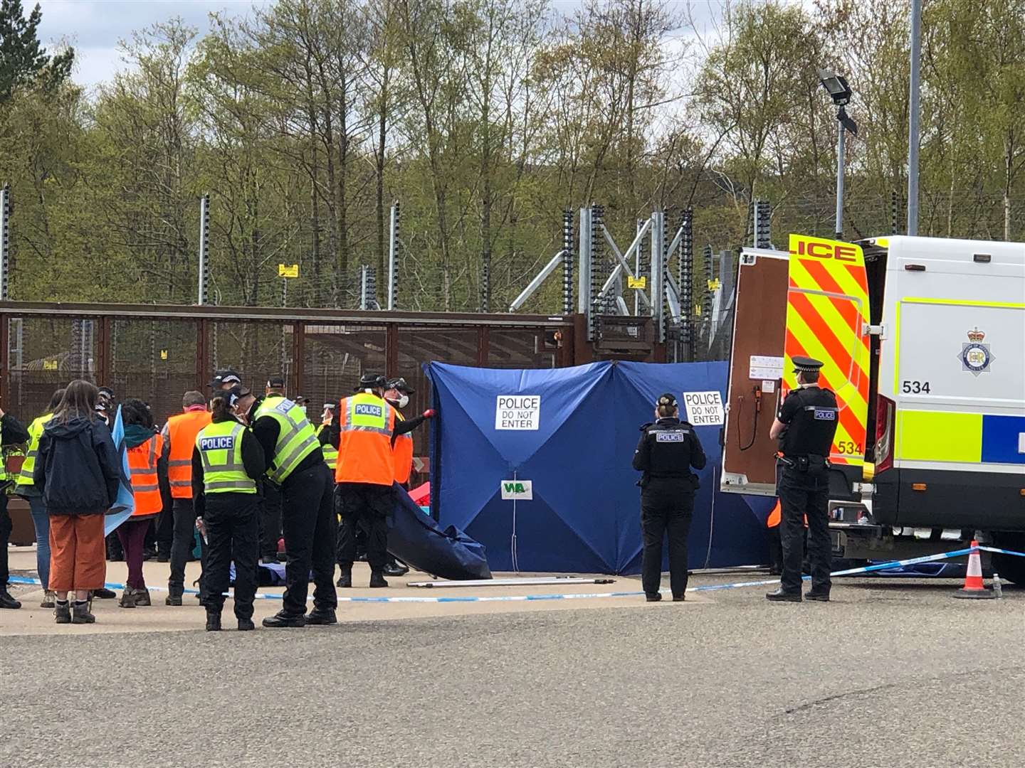 Police erected screens as they began attempts to remove protesters at Faslane (Douglas Barrie/PA)