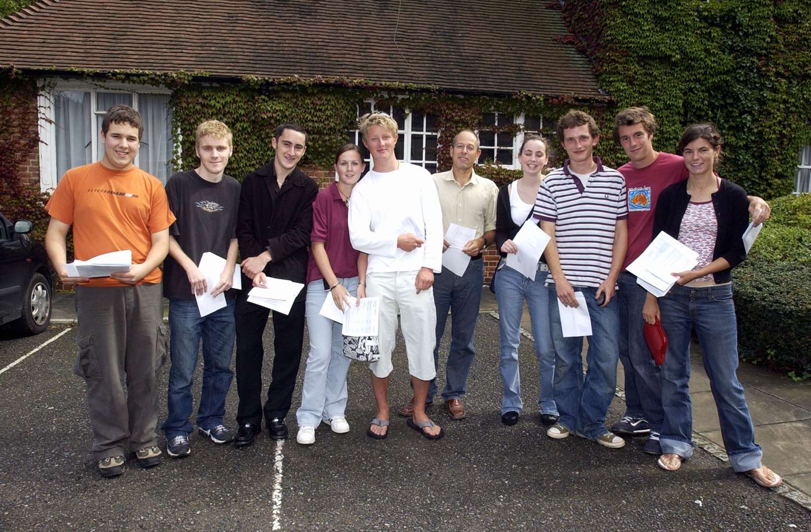 Headteacher at Sir Roger Manwood School in Sandwich, Chris Morgan, with a group of successful pupils in 2004. Picture: Gerry Whittaker