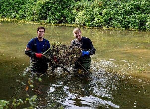 Cllr Alister Brady (Right) and another volunteer fishing a trolley from the Stour. Picture: Simon Pettman